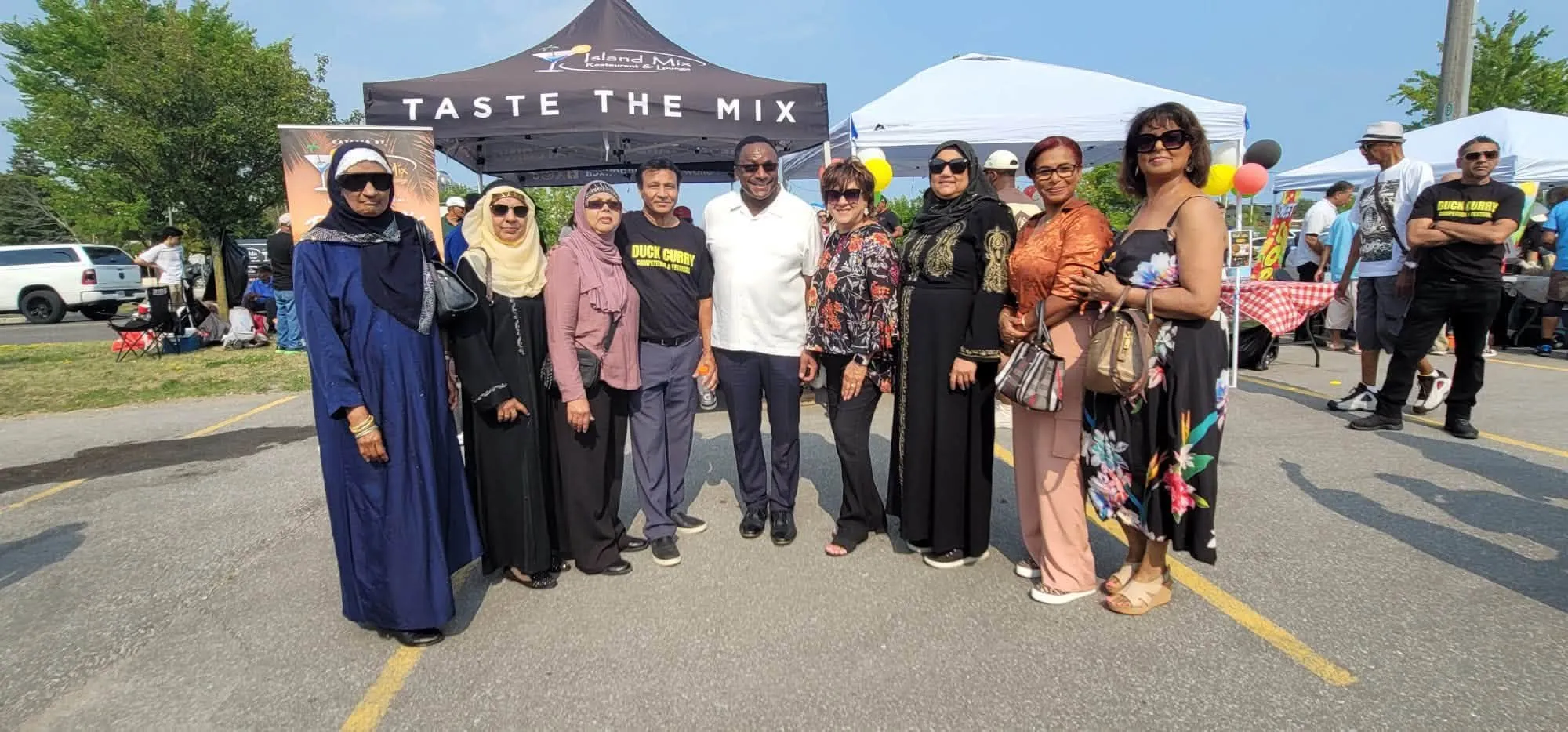 A group of guests and organizers posing together at the Duck Curry Festival
