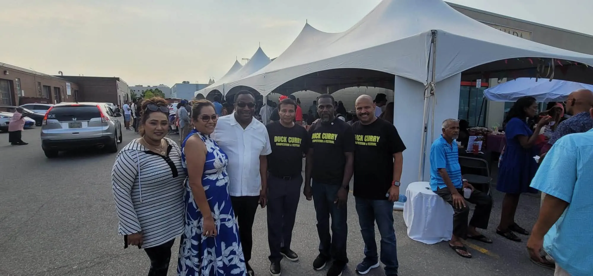 Organizers in matching Duck Curry shirts with guests at the fundraiser