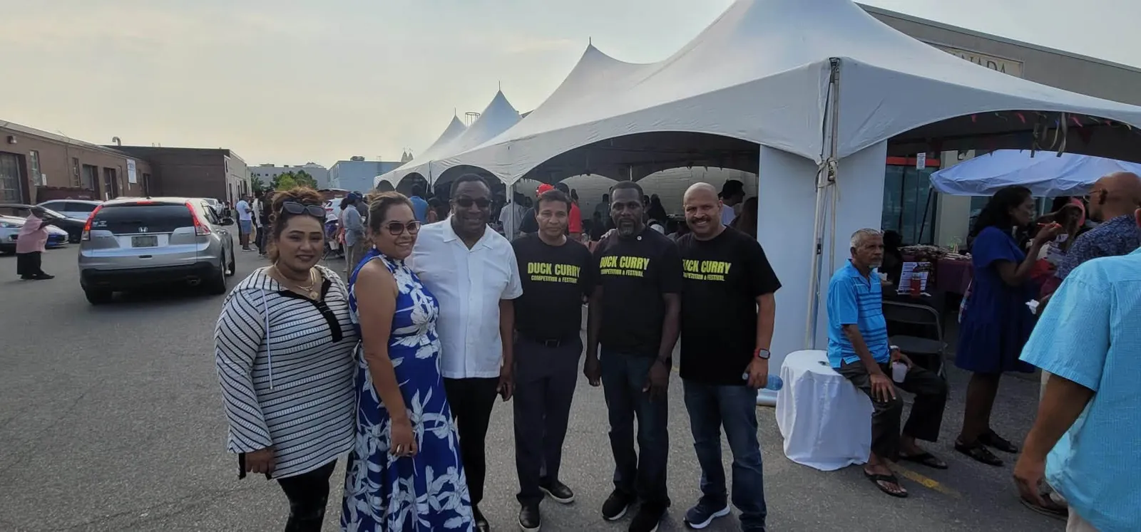 Organizers in matching Duck Curry shirts with guests at the fundraiser