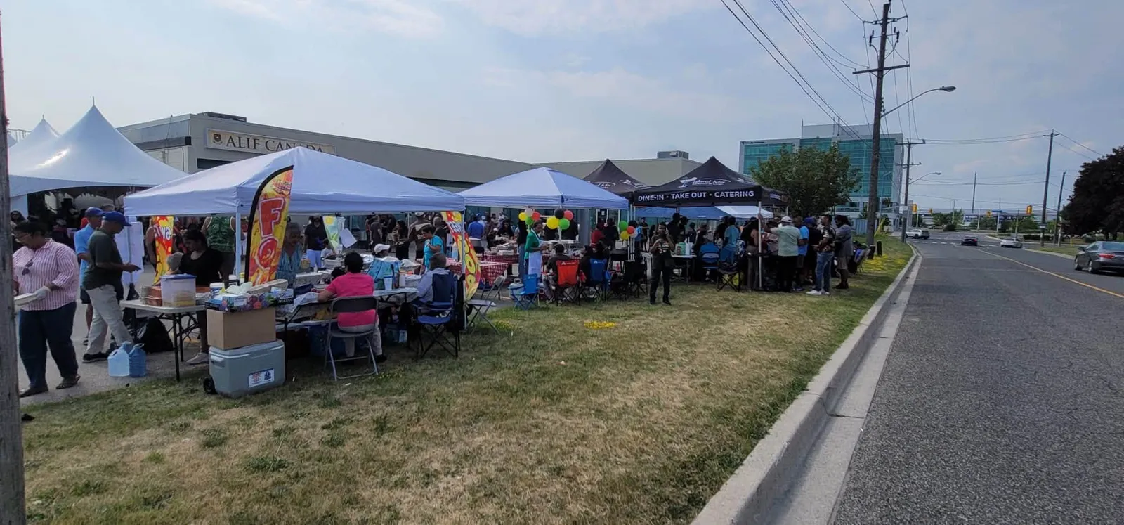 Food stalls and guests along the street at the One Love Duck Curry Festival