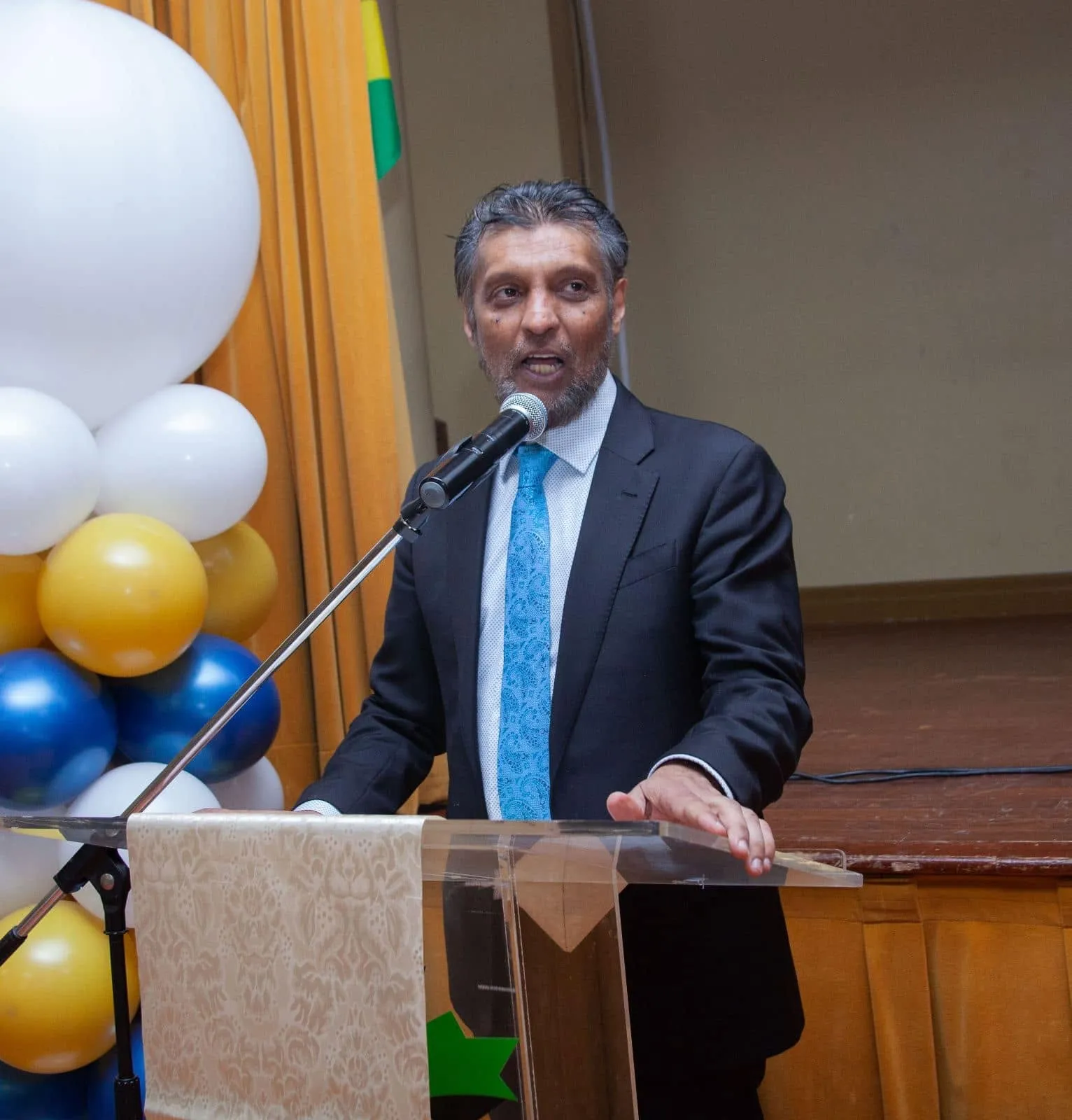 A speaker addressing guests from the podium at the gala