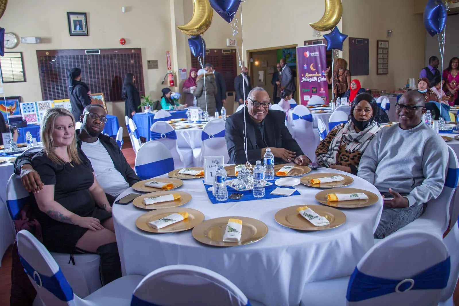 Guests seated at a dressed dinner table at the gala
