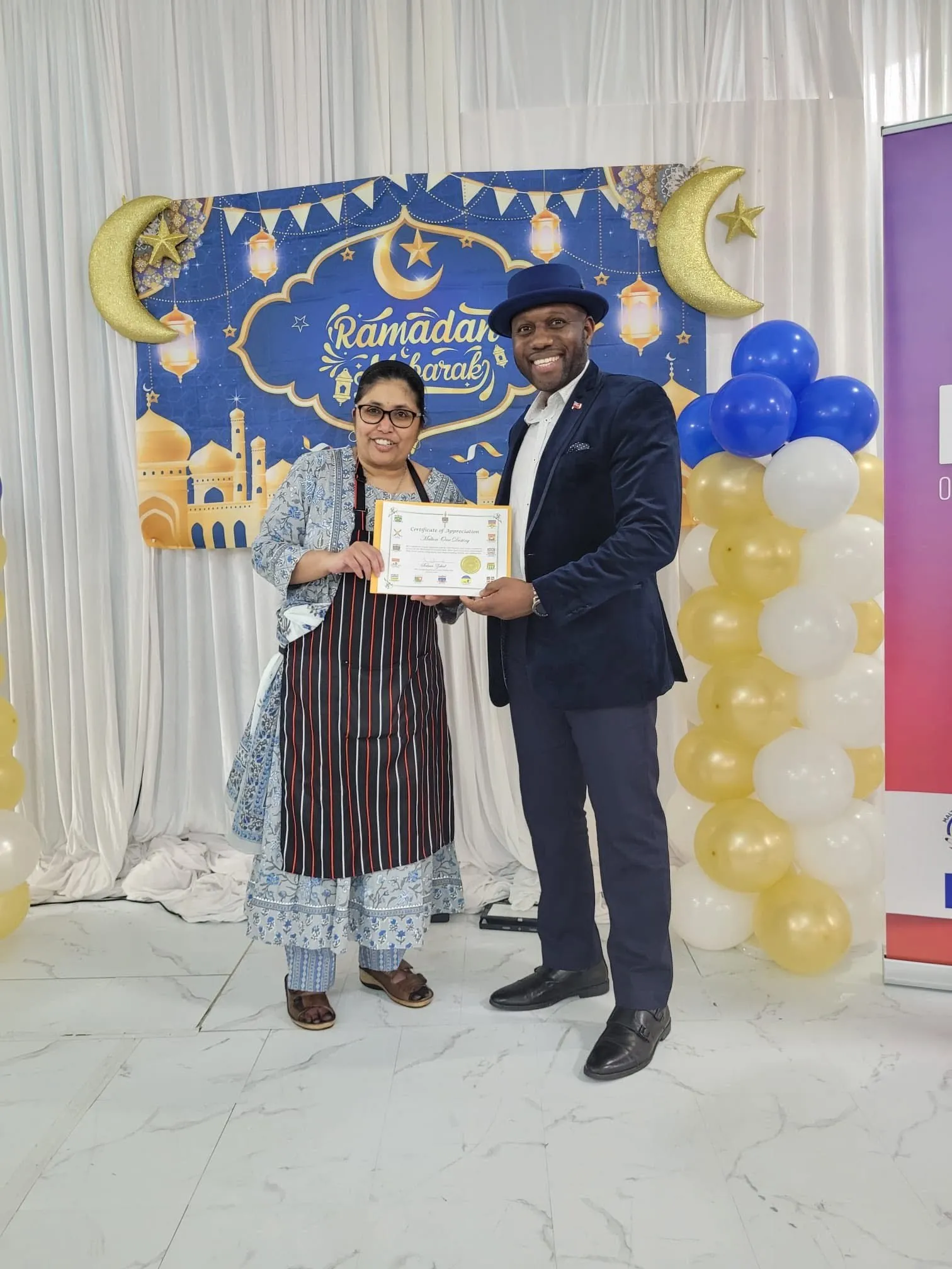 A guest receiving a certificate of appreciation at the interfaith dinner