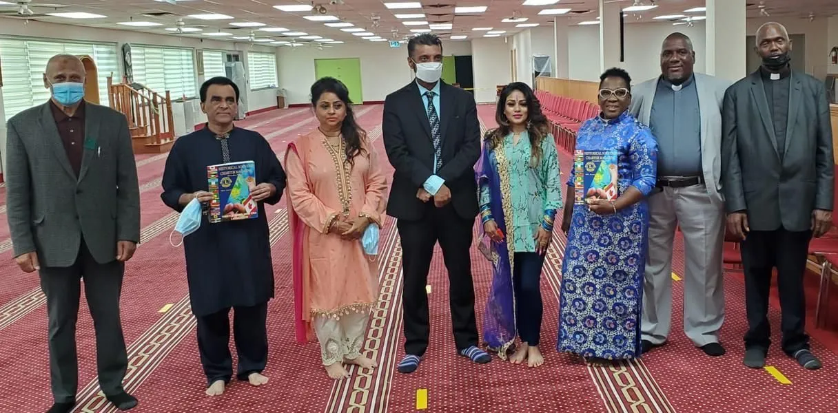 One Love Family Services members with interfaith community partners in a mosque prayer hall